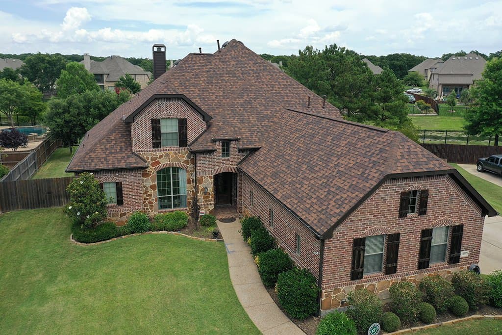 Aerial view of a finished Results Roofing home in North Texas with a new architectural shingle roof